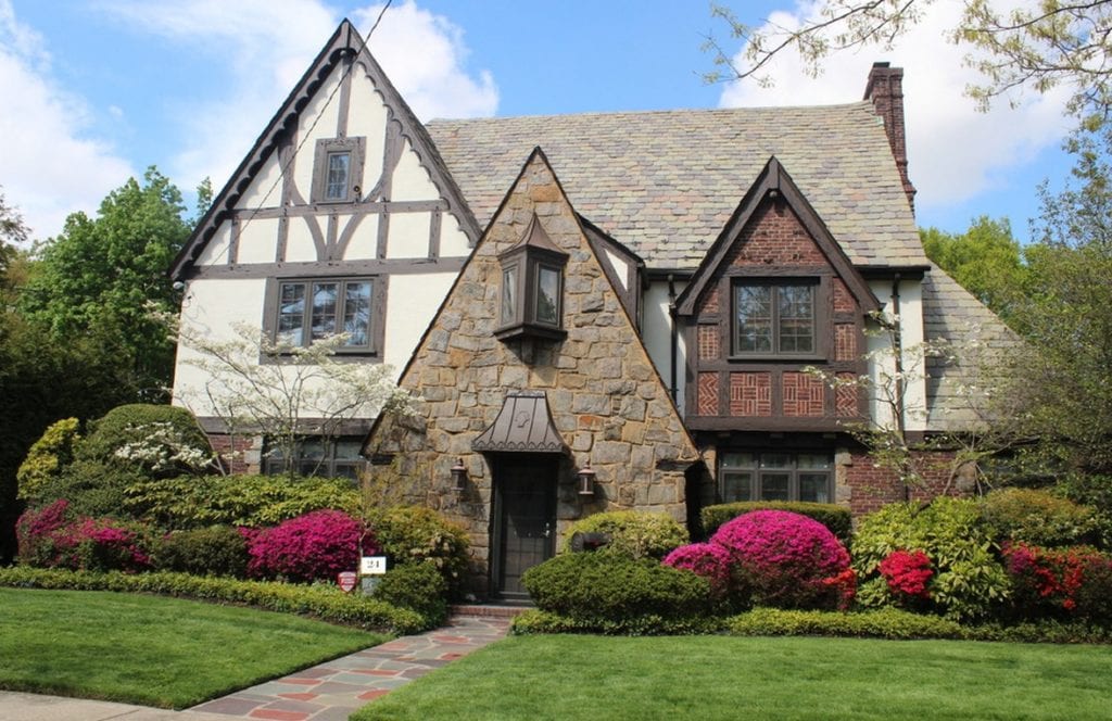 A tudor style home with brick and wooden enhancements 